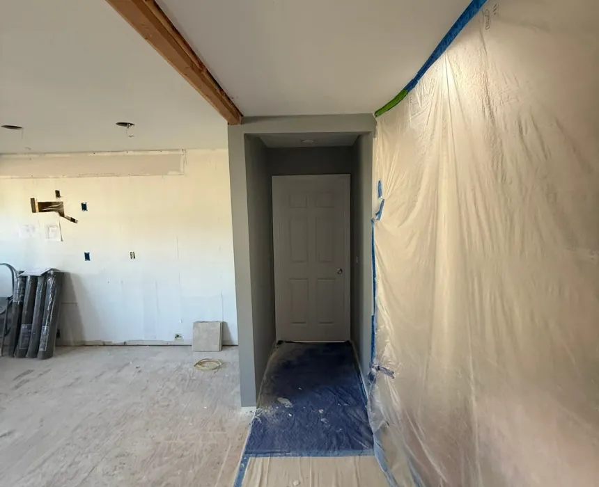Room masked with plastic sheeting and floor protection before spraying