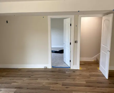 Room repainted in off-white with white doors and trim
