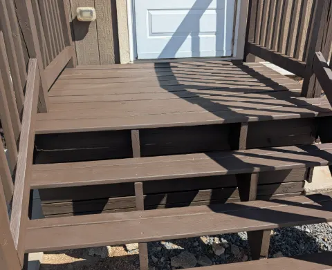 Deck steps and railing coated in a solid brown stain